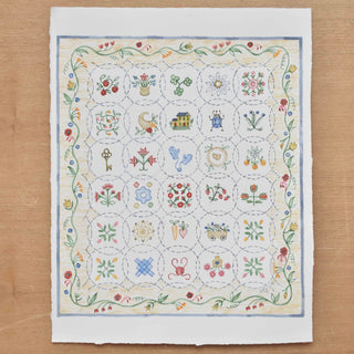 Flatlay image of original "American Quilt Alphabet" Painting by Sally King McBride of The Letter Nest, signed and dated 2026