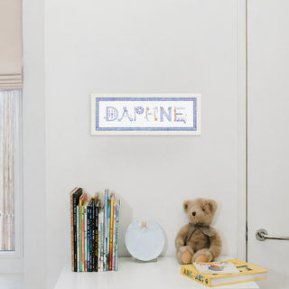 Astrology Custom Name Print by The Letter Nest in white frame with blue gingham border hung up in nursery