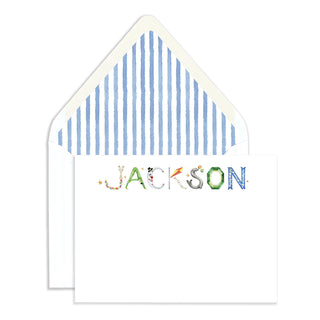 Flatlay of The Letter Nest's Circus Personalized Stationery with "Jackson" name in circus letters and blue envelope liner