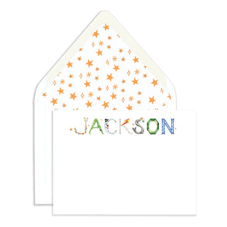 Personalized Circus Stationer by The Letter Nest in name "Jackson" against an envelope with watercolor star patterned liner
