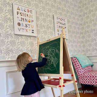 Photo of a girl at an easel with The Letter Nest's Dessert Alphabet in a white frame hanging in the background