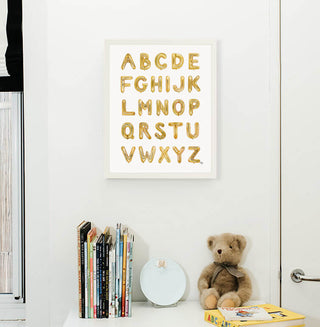 Gold Balooon Alphabet from The Letter Nest, White Frame installed in nursery