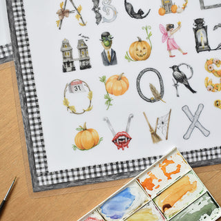 Detail photo of The Letter Nest Halloween Alphabet Placemat, educational placemat for the kids table featuring Halloween letters painted and printed watercolor A to Z