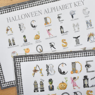 Detailed photo of The Letter Nest Halloween Alphabet Placemat Key, educational placemat for the kids table featuring Halloween letters painted and printed watercolor A to Z, with a letter key identifying each illustration