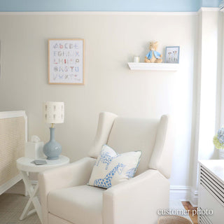 Nautical Alphabet Print in a Natural Frame by The Letter Nest hanging in a light-filled nursery
