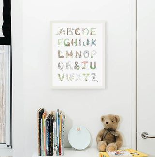 Woodland Alphabet in a White Frame from The Letter Nest, shown in a children's nursery